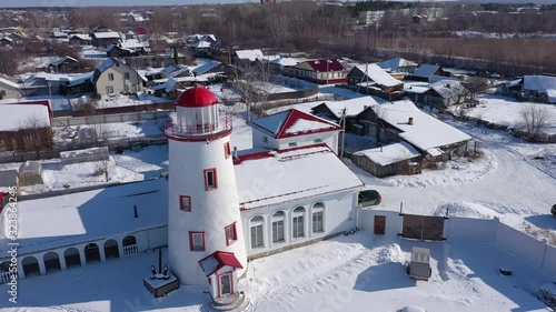 Top view of a lighthouse on the shore in winter