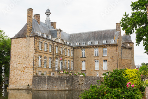 The castle of Flers, now a museum (Normandy, Orne, France). Beautiful medieval architecture. Wide-angle shot of this historical monument. Surrounded by a moat. Cloudy day. 
