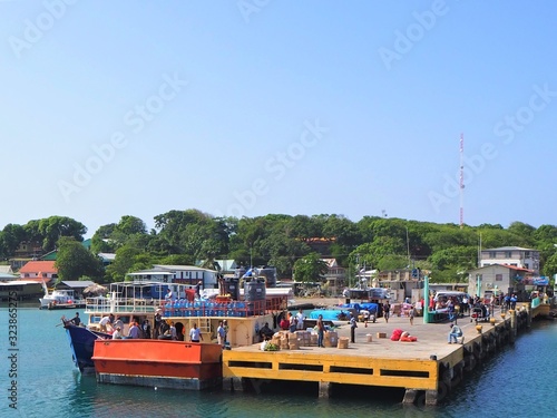 arriving at dive paradise of utilla island. utila, honduras, central america