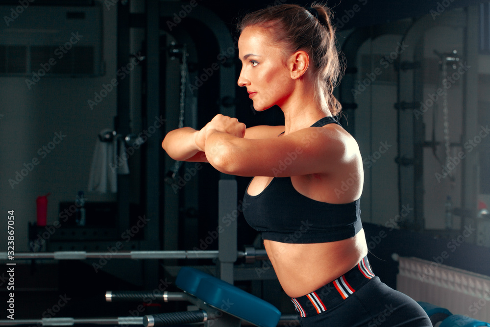 Slim girl working out in training apparatus