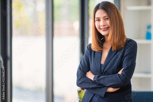 Pleased asian business woman with crossed arms looking at the camera. Free Download Pleased asian business woman with crossed arms looking at the camera. - GFXLoad