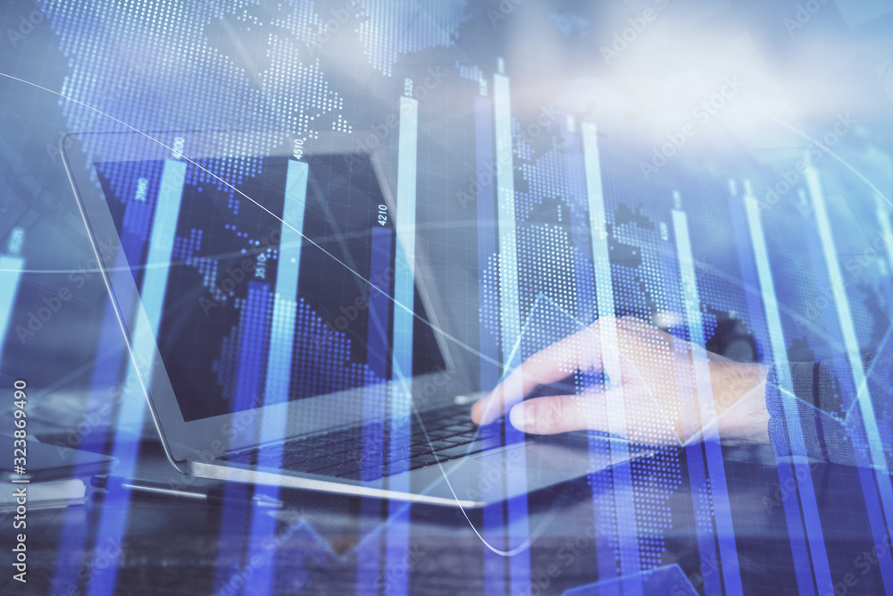 Double exposure of stock market graph with man working on laptop on background. Concept of financial analysis.