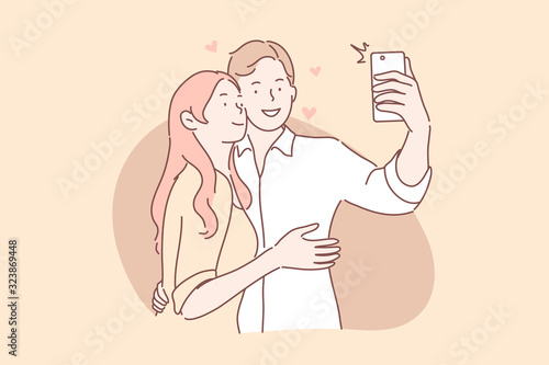 Couple in love take selfie concept. Boyfriend and girlfriend man and woman hug and makes photo or take picture on smartphone together. Couple in love takes joint selfie. Social media communication.