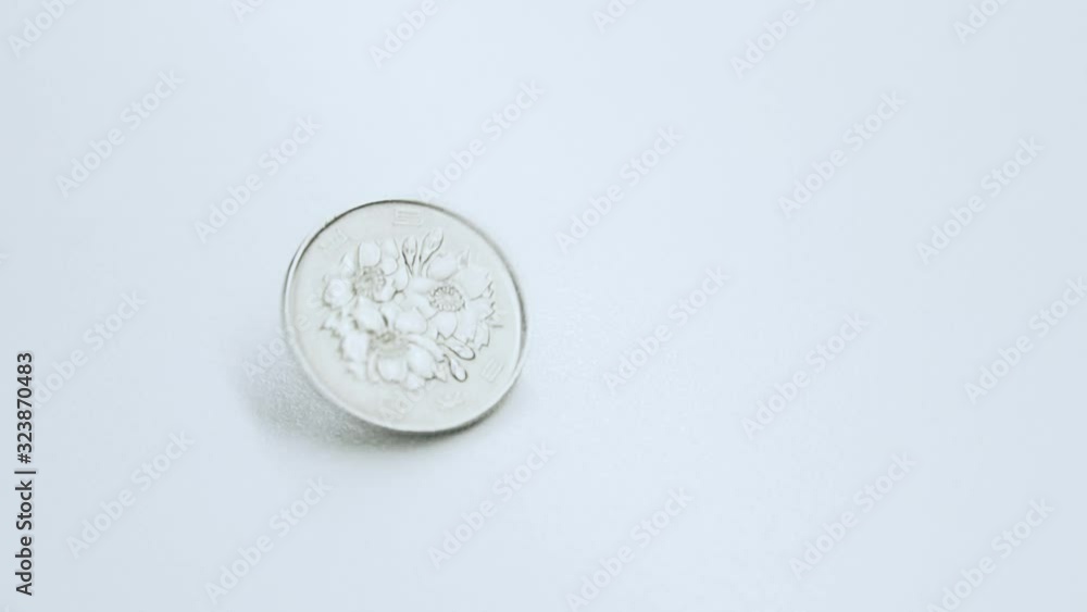 japanese currency yen money coin spin and stop on white background table. Background concept for japan economy. japanese currency yen money coin spin and stop on white background table. Background concept for japan economy.
