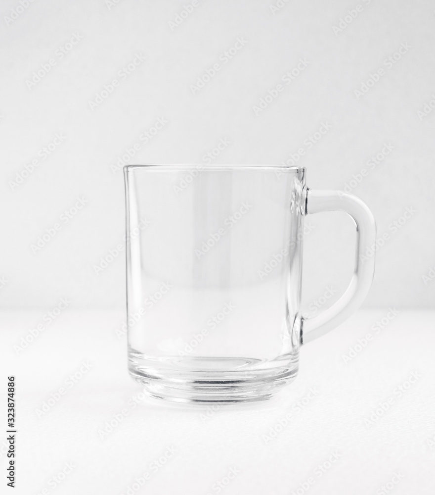Empty blank transparent teacup or coffee cup isolated on white Empty blank transparent teacup or coffee cup isolated on white