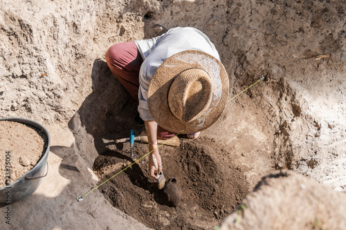 Bild auf Leinwand Archaeology - Archeologist Revealing Old Ceramic Object