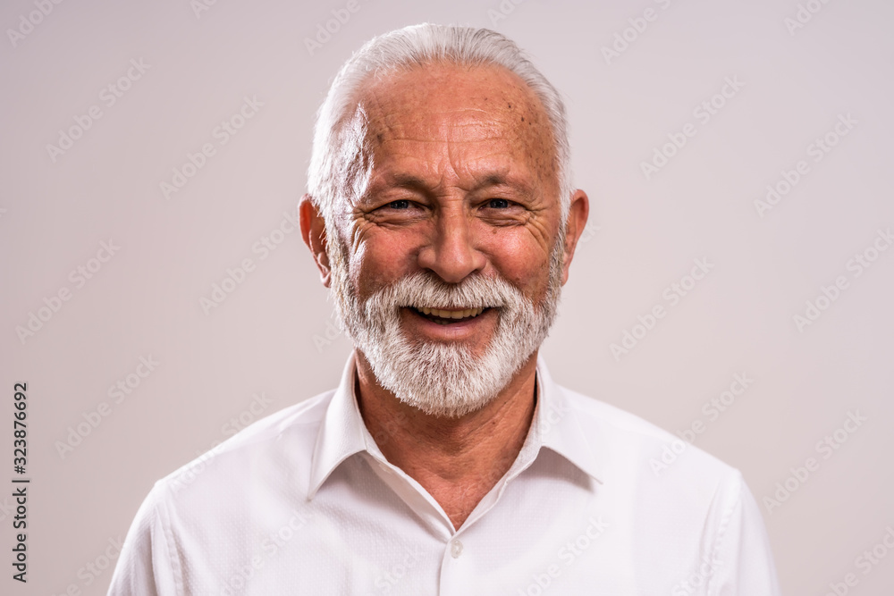 Portrait of cheerful senior man who is looking at camera and smiling. Portrait of cheerful senior man who is looking at camera and smiling.