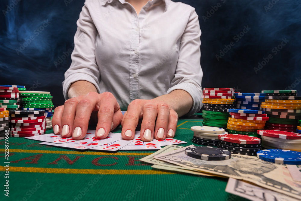 Playing poker in a casino, giving out cards, money and game chips. A game in a casino, gaming business Playing poker in a casino, giving out cards, money and game chips. A game in a casino, gaming business