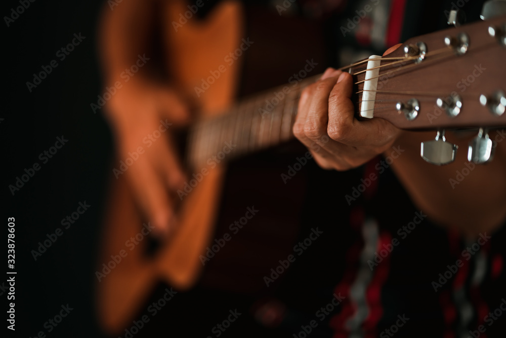 Fototapeta premium Close up guy's hand playing guitar.