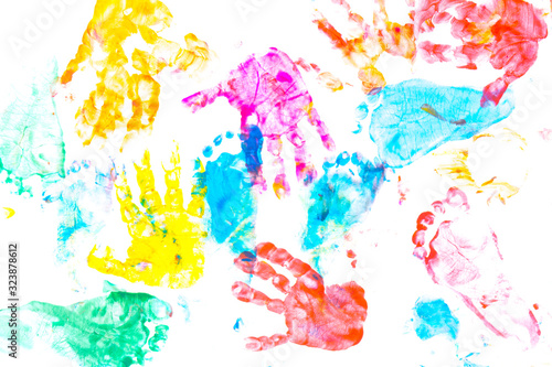 multicolored prints of children's hands and feet on white background. Abstract painted background. Children's art and painting.