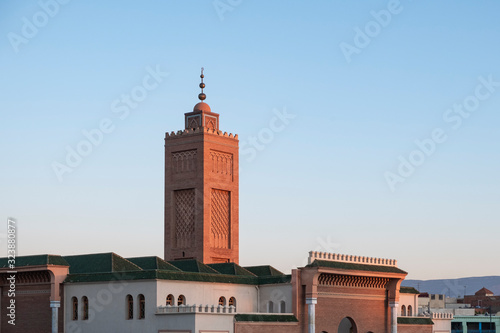 Red minaret of the Great Mosque in Oujda in the evening with clear blue sky photo