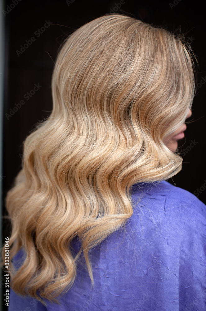 Long hair of a blonde woman with wave hairstyle Long hair of a blonde woman with wave hairstyle