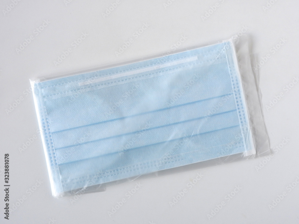 Top view of two blue disposable surgical mask isolated on white background. Novel coronavirus (COVID-19). Health and medical concept. In Taiwan, each customer limited to two pieces per week. Face mask Top view of two blue disposable surgical mask isolated on white background. Novel coronavirus (COVID-19). Health and medical concept. In Taiwan, each customer limited to two pieces per week. Face mask