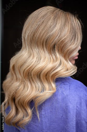 Long hair of a blonde woman with wave hairstyle