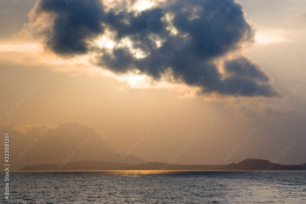 Backlit cloud over the sea at sunset