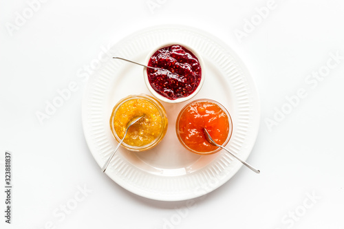 Fruit jams. Colorful dessert in bowls on white kitchen desk