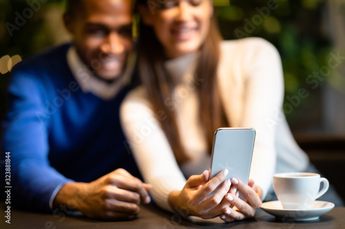 Portrait of afro guy and caucasian girl using cellphone
