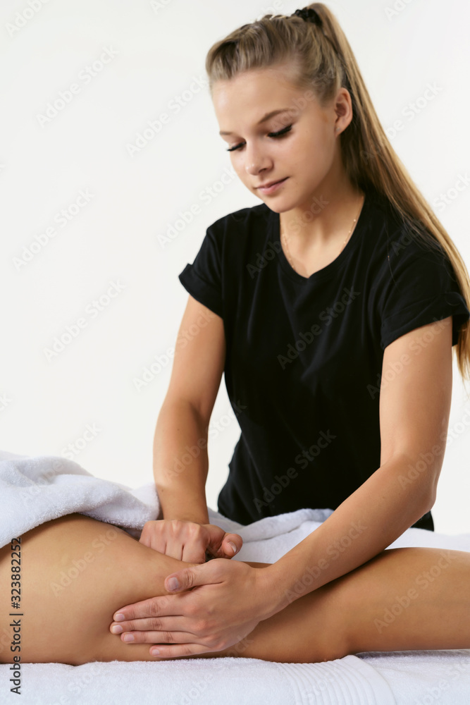 Anti cellulite massage for young woman in beauty salon. Masseur at work in beauty salon wellness center. Perfect skin fat burning beauty concept