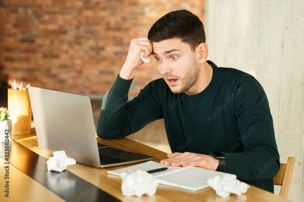 Overworked Young Man At Laptop Crumpling Paper Working In Office Overworked Young Man At Laptop Crumpling Paper Working In Office