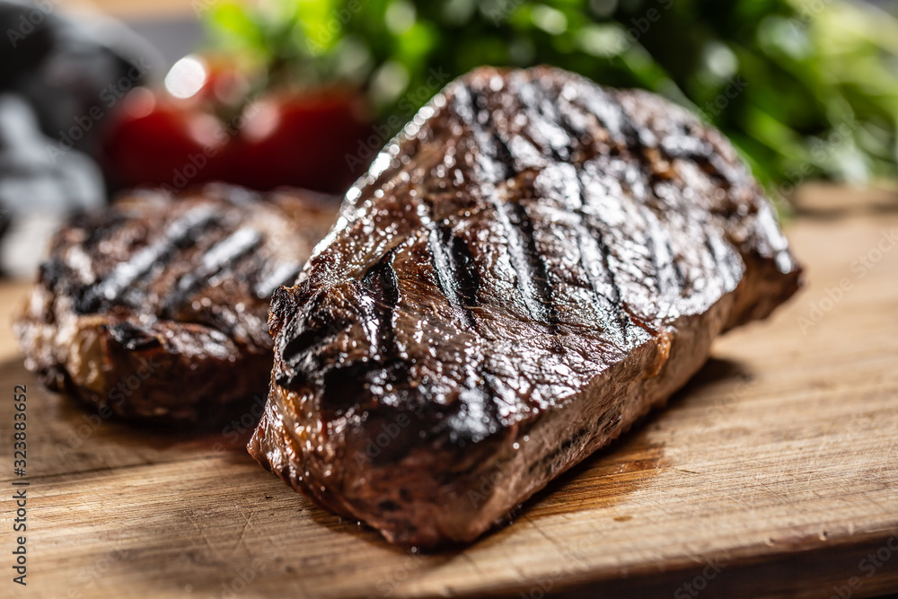 Juicy beef rib eye steak with herbs tomatoes salt and spices Juicy beef rib eye steak with herbs tomatoes salt and spices