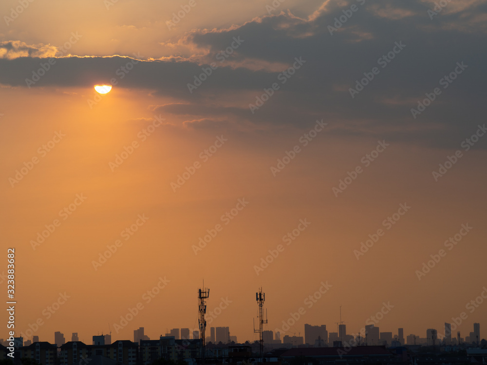 Sunrise over buildings in city. Skyline view of cityscape with sunlight  in warm light color tone