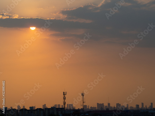 Sunrise over buildings in city. Skyline view of cityscape with sunlight  in warm light color tone