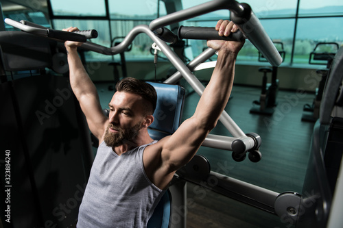 Bodybuilder Doing Heavy Weight Exercise For Shoulders