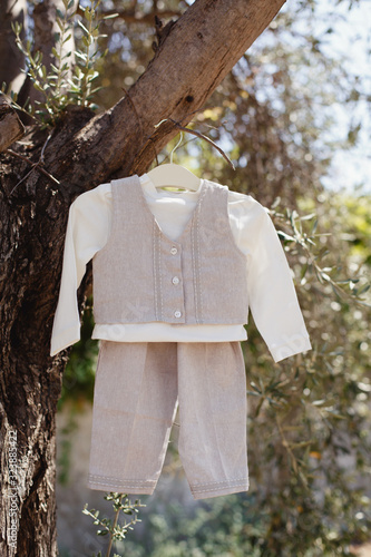 Christening dress, clothes. White cute  linen suit for little guy on olive tree. Cyprus traditional christening. Baptism, Suit for little fashion boy photo