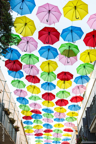 sky with umbrellas. Beautiful display of colorful hanging umbrellas along a street. Umbrella Sky. Colorful umbrella roof. Natural tourist attractions Decorated with many umbrellas hanging on the walls