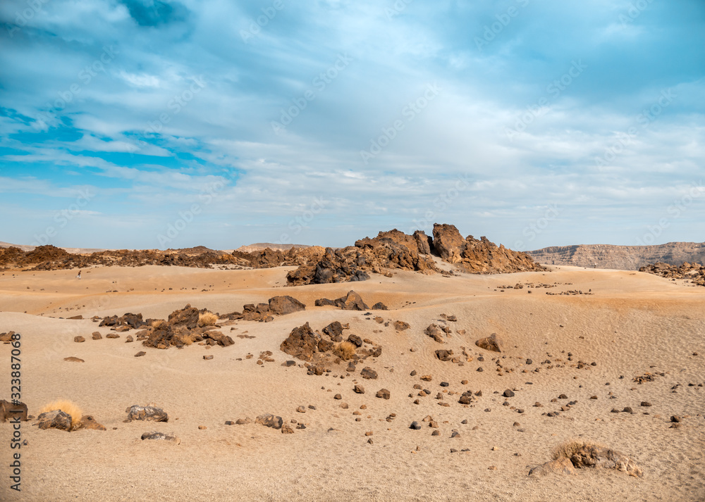 Beautiful landscape of volcanic desert and sharp stones against bright blue sky