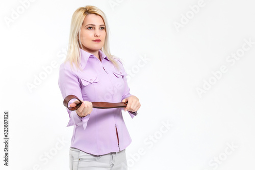 woman holds a belt on a white background