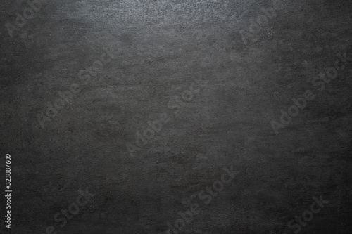 dark gray concrete stone wall with light gradient and copy space