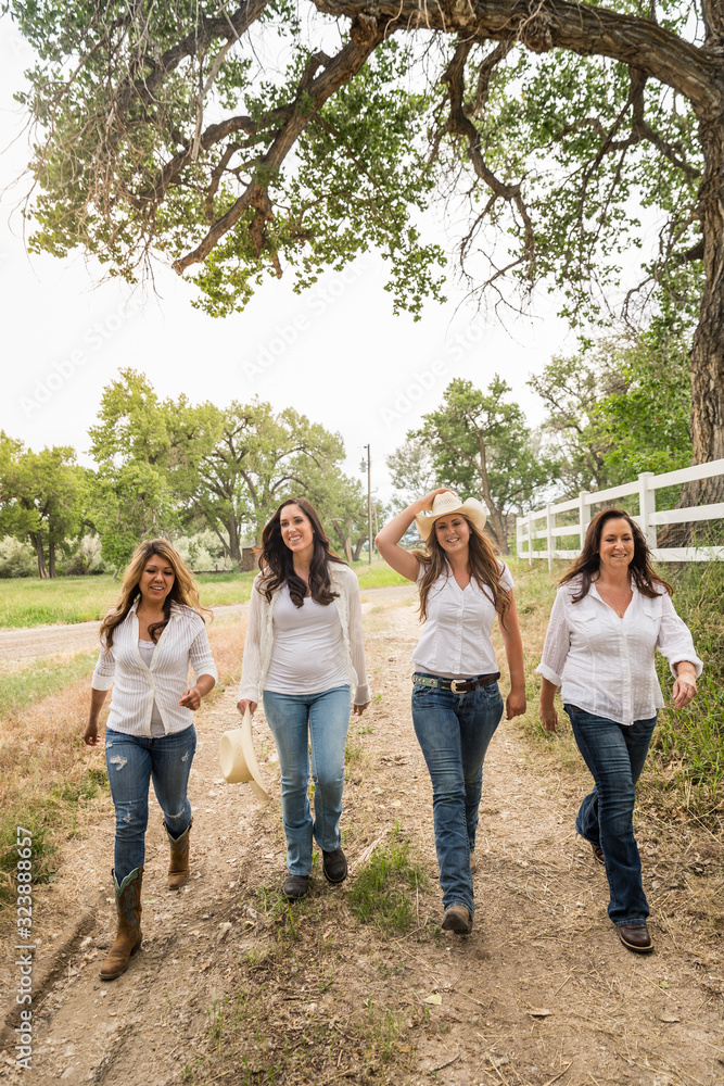 Four western girls walking in line up the drive. Bridger, Montana, USA Four western girls walking in line up the drive. Bridger, Montana, USA