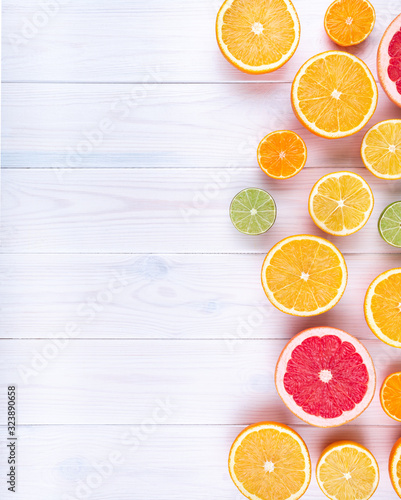 Citruses on white wooden background