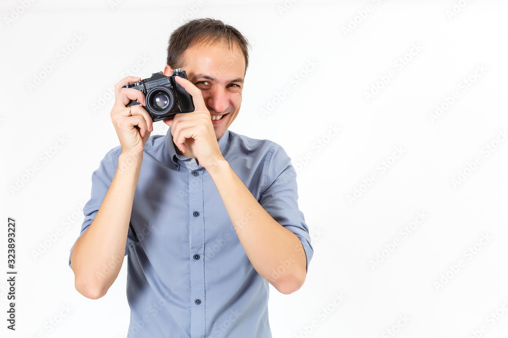 Handsome young man holding a camera. On white. Handsome young man holding a camera. On white.