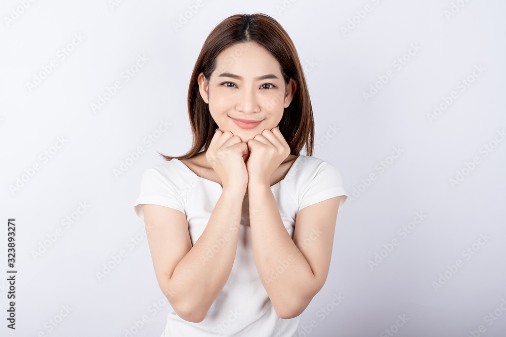 Beautiful young asian woman pretending to be happy with big smile happy beaming face in white isolated background. Beautiful young asian woman pretending to be happy with big smile happy beaming face in white isolated background.
