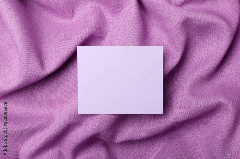 Top view of blank cardboard on the purple linen fabric.Empty card for sale text, prices or design Top view of blank cardboard on the purple linen fabric.Empty card for sale text, prices or design