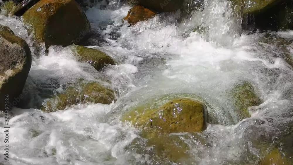 Mountain river with foam close up. Slow motion. Mountain river with foam close up. Slow motion.