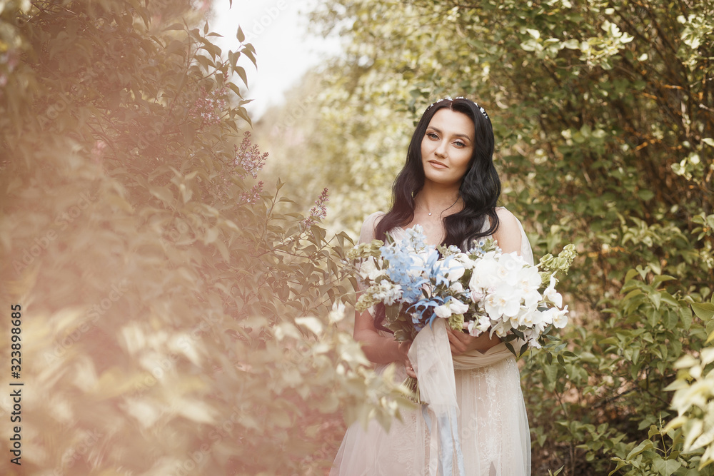 beautiful young bride with a big bouquet in her hands on a lilac background beautiful young bride with a big bouquet in her hands on a lilac background