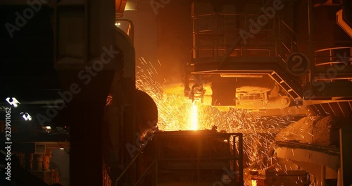 Liquid metal in the factory, foundry, smelting iron and processing. Iron and Steel Works. Pouring of molten iron.