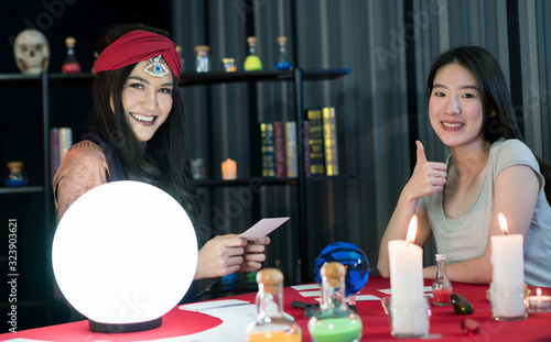 The fortune teller is predicting the fortune.