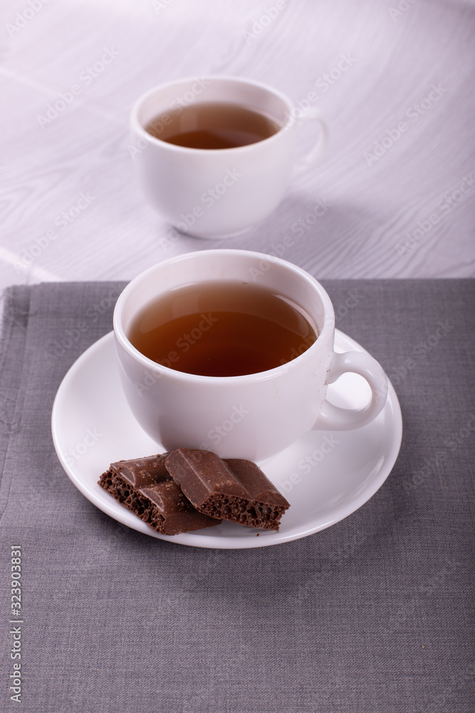Cup of tea and chocolate with light background Cup of tea and chocolate with light background