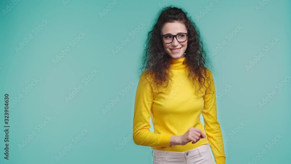 smiling woman throwing paper plane isolated on turquoise smiling woman throwing paper plane isolated on turquoise