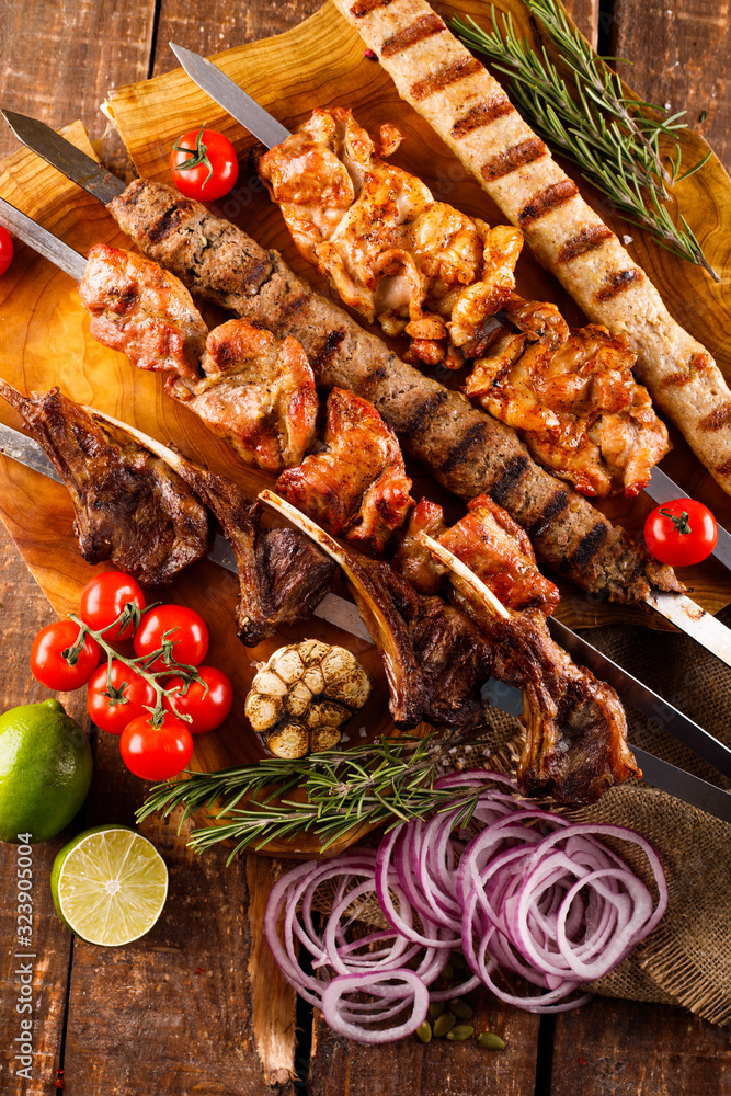 Fresh, homemade beef kebab with vegetables and spices, with barbecue sauce and ketchup