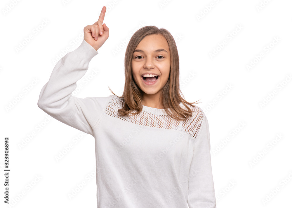 Portrait of smiling teen girl pointing a great idea, isolated on white background. Awesome idea. Beautiful young teenager keeping finger up, looking at camera. Happy cute child have unexpected idea. Portrait of smiling teen girl pointing a great idea, isolated on white background. Awesome idea. Beautiful young teenager keeping finger up, looking at camera. Happy cute child have unexpected idea.