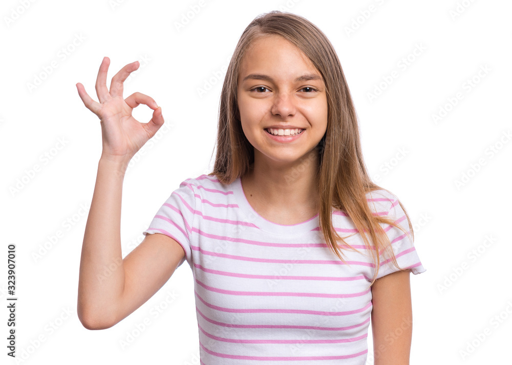 Portrait of teen girl making Ok Gesture, isolated on white background. Beautiful caucasian young teenager smiling and giving OK sign. Happy cute child showing okay. Portrait of teen girl making Ok Gesture, isolated on white background. Beautiful caucasian young teenager smiling and giving OK sign. Happy cute child showing okay.