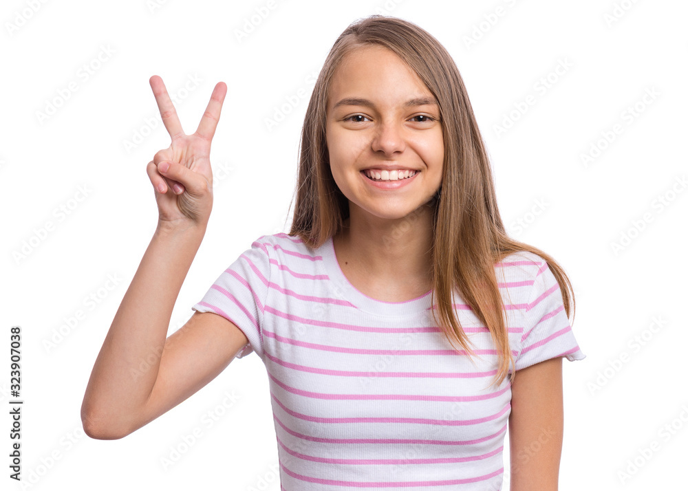 Portrait of successful teen girl winner making Victory Gesture, isolated on white background. Beautiful caucasian young teenager. Happy cute child showing success sign and looking at camera. Portrait of successful teen girl winner making Victory Gesture, isolated on white background. Beautiful caucasian young teenager. Happy cute child showing success sign and looking at camera.