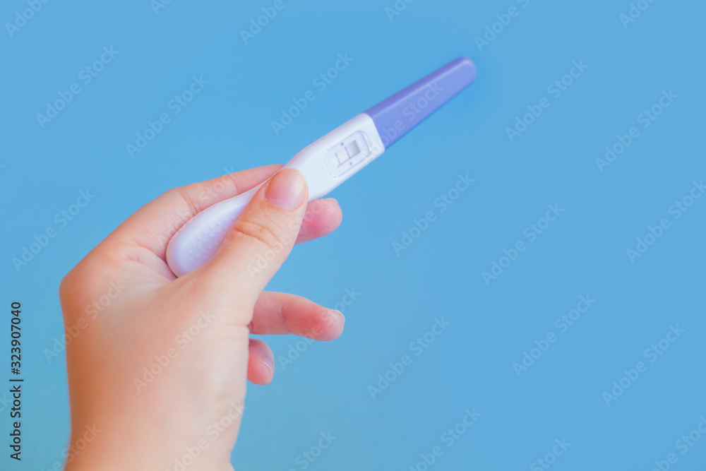 Positive pregnancy test with two strips on pink Positive pregnancy test with two strips on pink