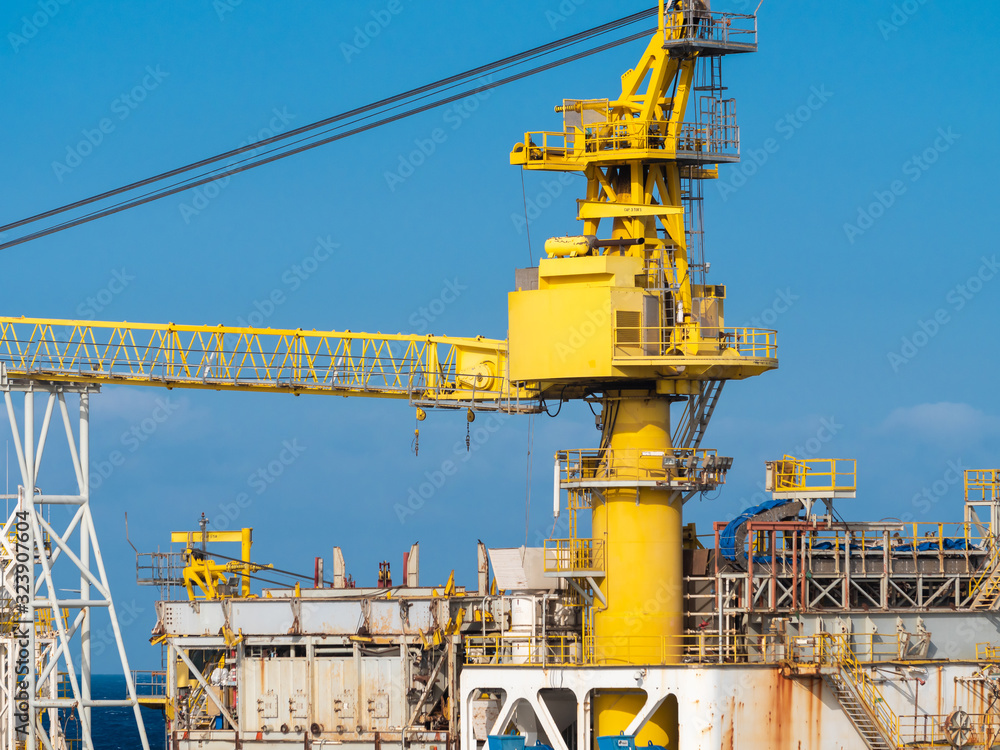 Image of big heavy yellow crane working in cargo port terminal Image of big heavy yellow crane working in cargo port terminal