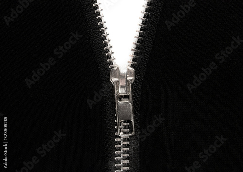 Open zipper or clothes lock on black fabric